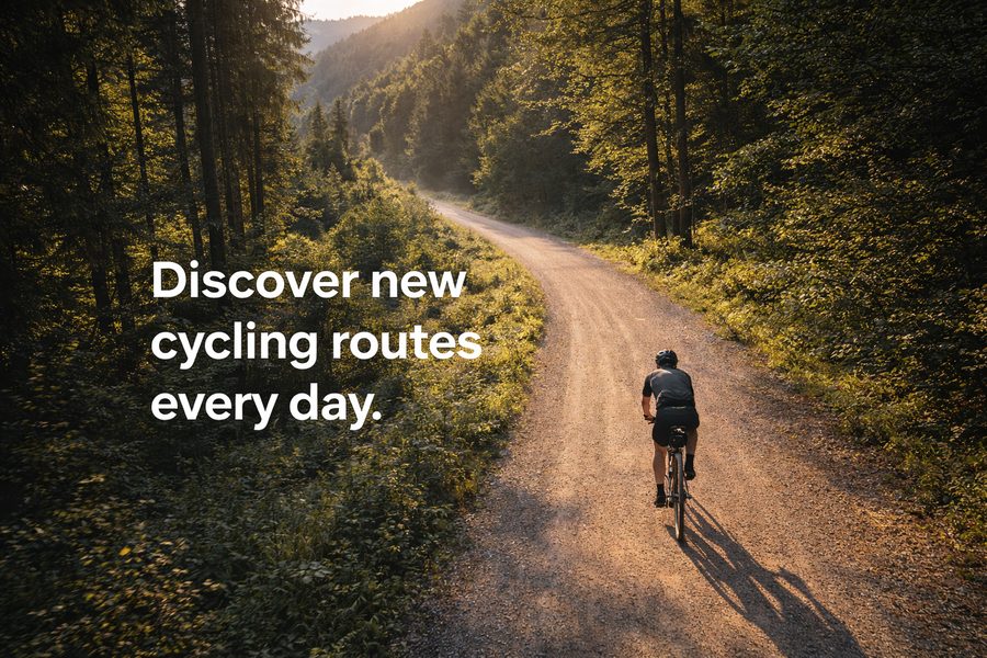 Cyclist on a gravel road through a forest — Discover new cycling routes every day